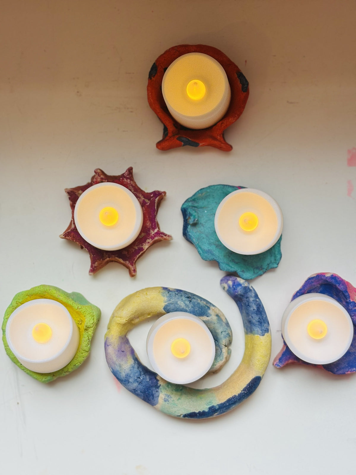Handmade salt dough diyas, painted and lit with tea lights