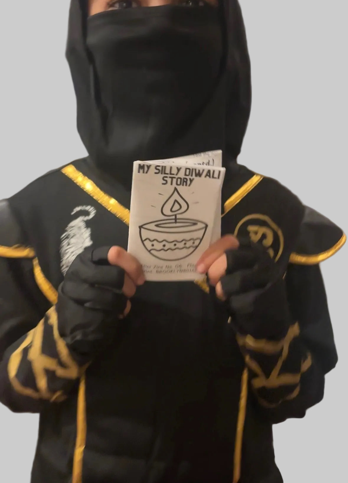 My Silly Diwali Story mini zine cover, held up after folding