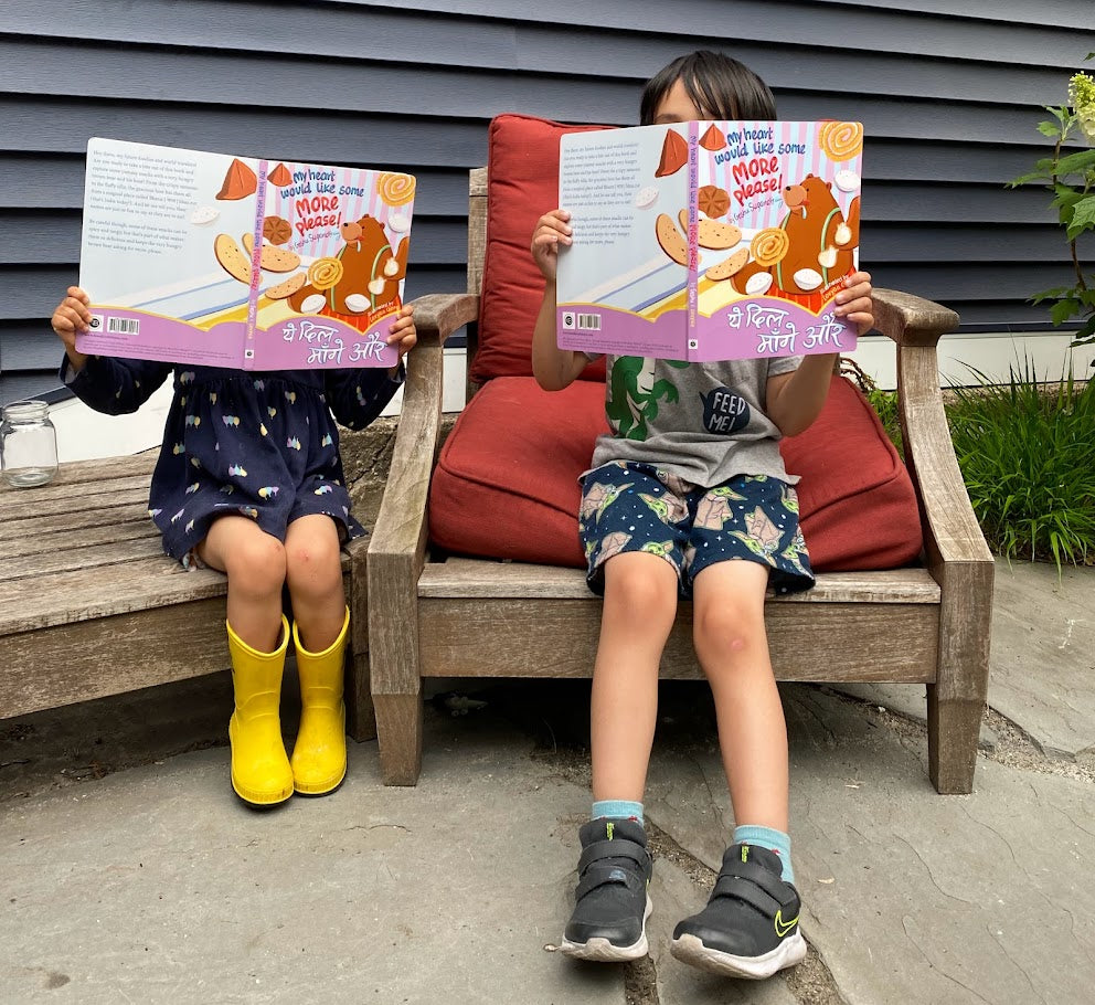 Two children enjoying the bilingual Hindi English  foodies board booko My Heart Would Like Some More, Please!