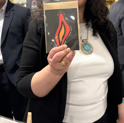 A visitor at the Chicago Indian Literature Festival holding the You Are the Diya Shubh Diwali card.