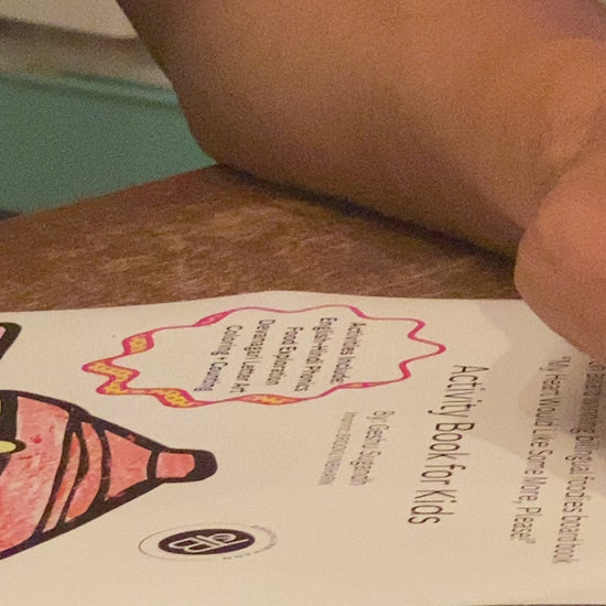 An adult aengaging in coloring activity of a chai pot from My Indian Tea Party Activity Workbook.