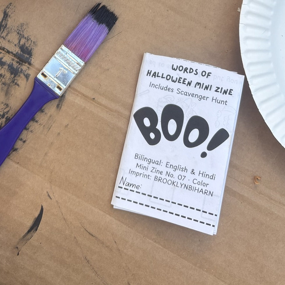 Words of Halloween mini zine cover next to a purple paintbrush